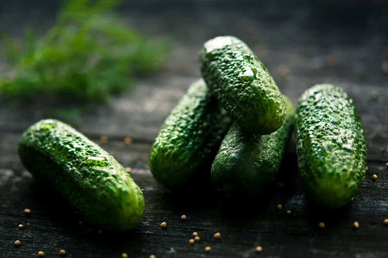 a bunch of pickles sit on a wooden board