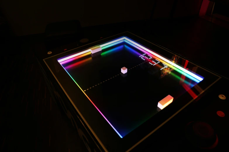 a lighted glass with several cubes lit up at night