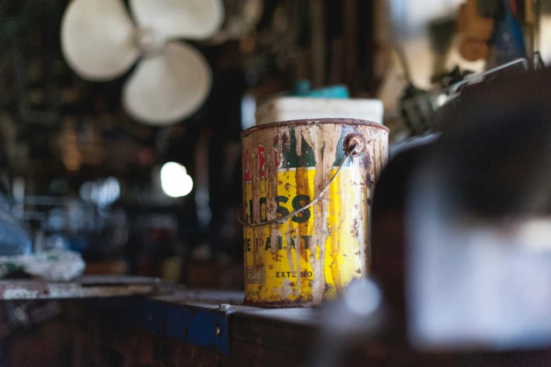 a coffee cup sitting on a wooden shelf in front of some lights