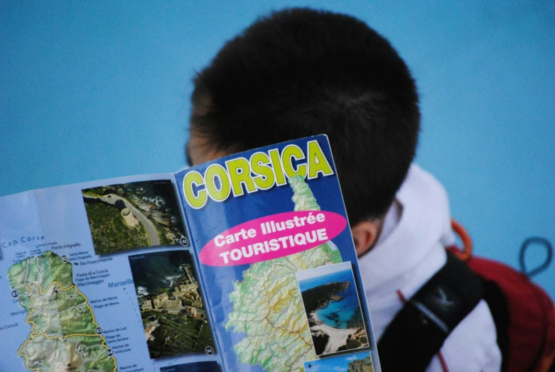 a man is reading a map with the names of a town