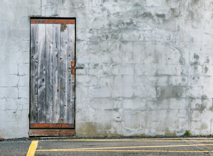 a door and building next to a parking meter