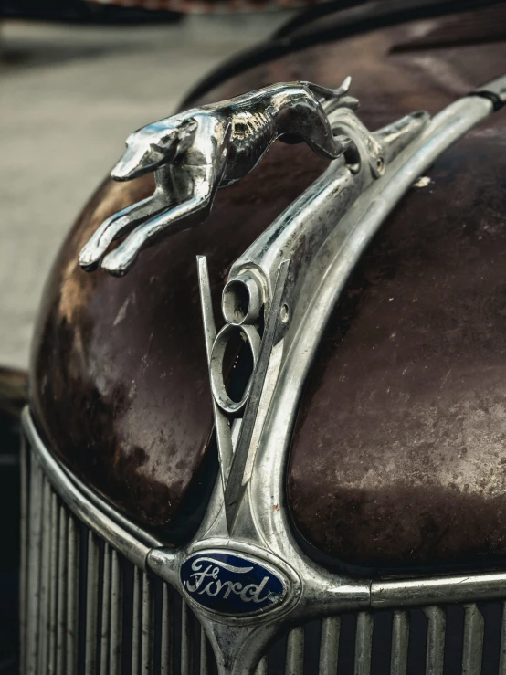 a vintage silver logo on top of a old car
