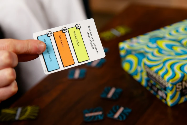 a person holding up a card that shows a color chart