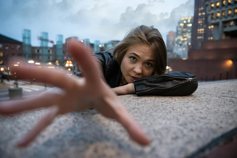 a woman posing for the camera with her hand in the air