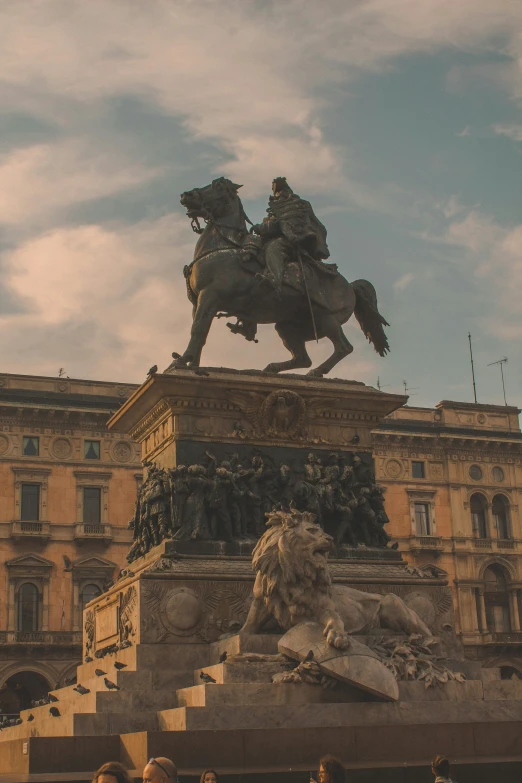 a statue sitting on top of a stone pillar