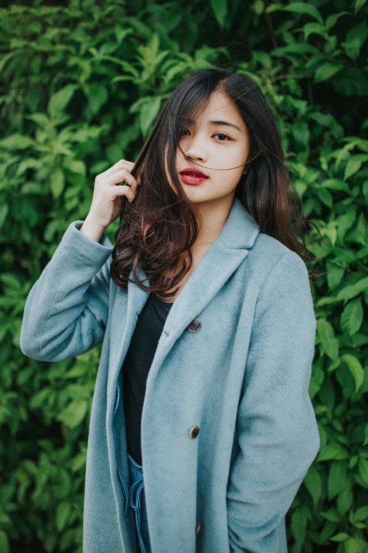 a woman with long hair posing for the camera