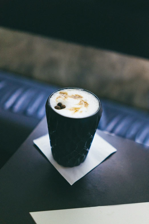 a cup with a beverage on a napkin