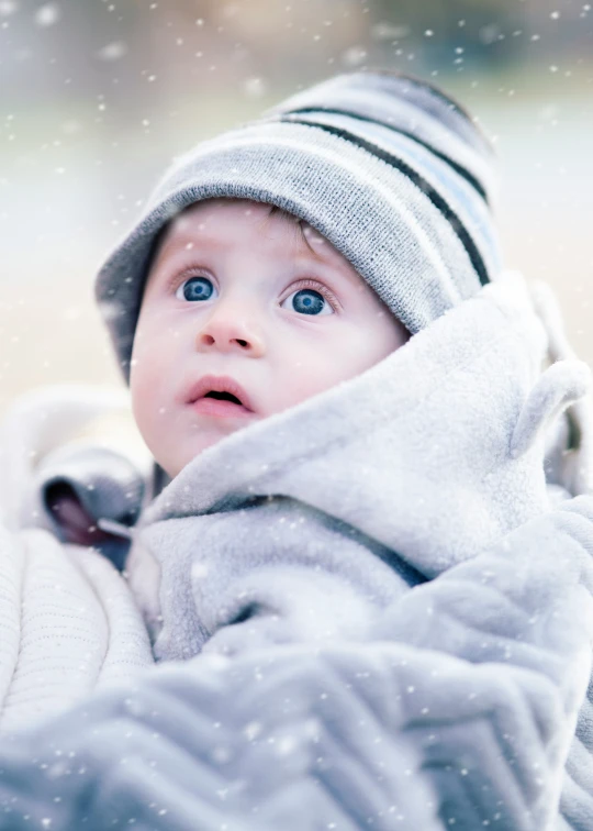 a baby with a hat and a blanket on it