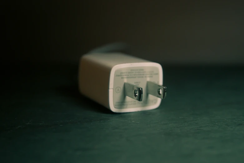 two plugs on a green table are placed in a rectangular shape