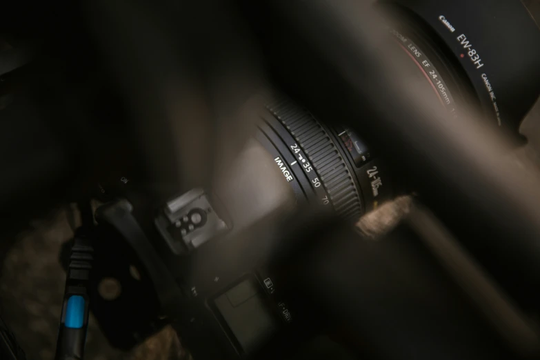 a lens and a computer are pographed through the fence