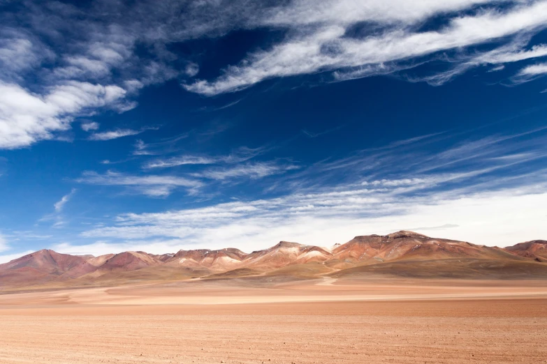 a big desert with a group of mountains in the background