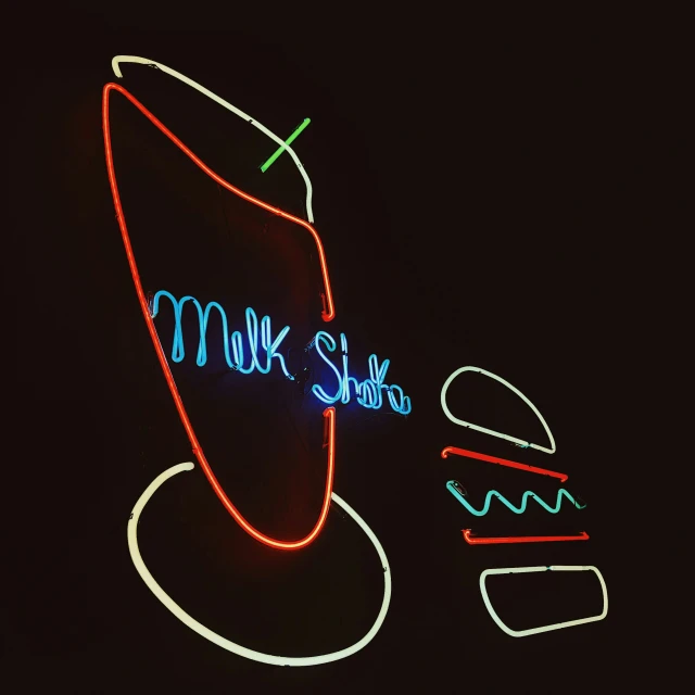 a neon drink is displayed in front of an advertit for a drink