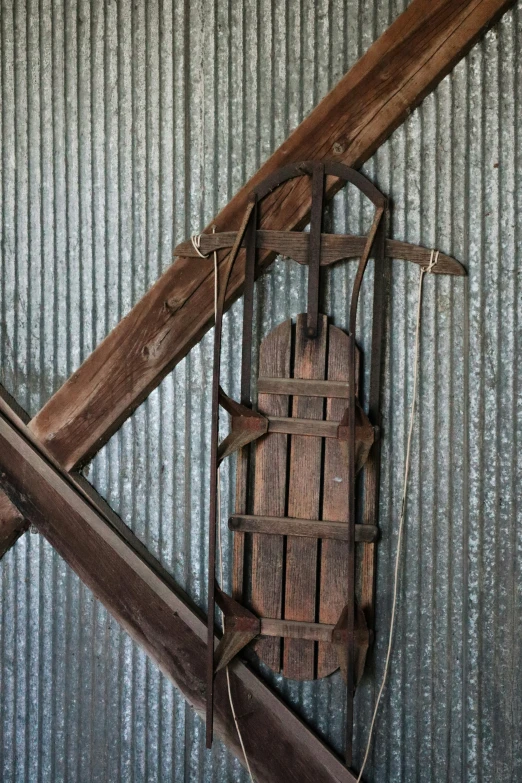 an old wooden device attached to the side of a building