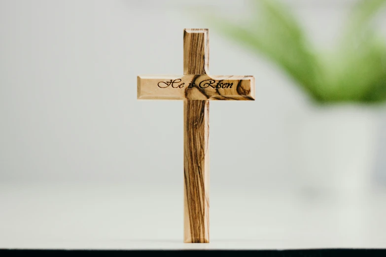 the cross has two wooden crosses with signs on it