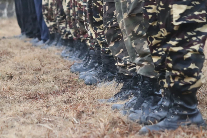 many military foot wear are lined up together