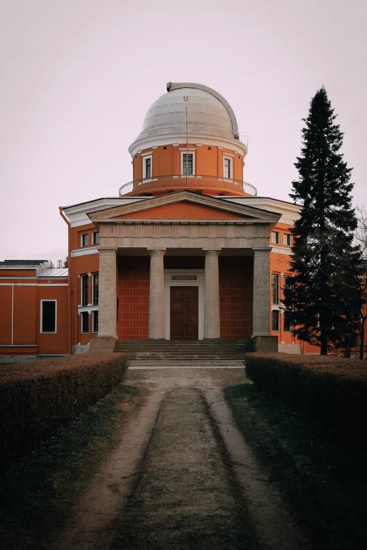 an orange building with a small dome
