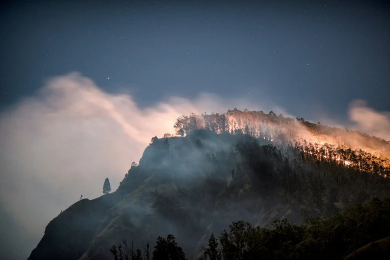 an image of a mountain covered with clouds