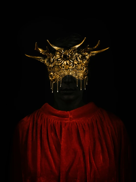 a person with a golden mask over his face