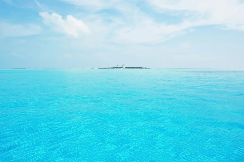 a blue water is shown with several island and some clouds