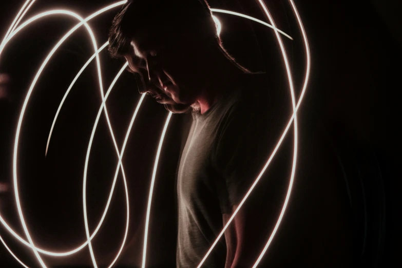 the man is illuminated by many long exposures of light