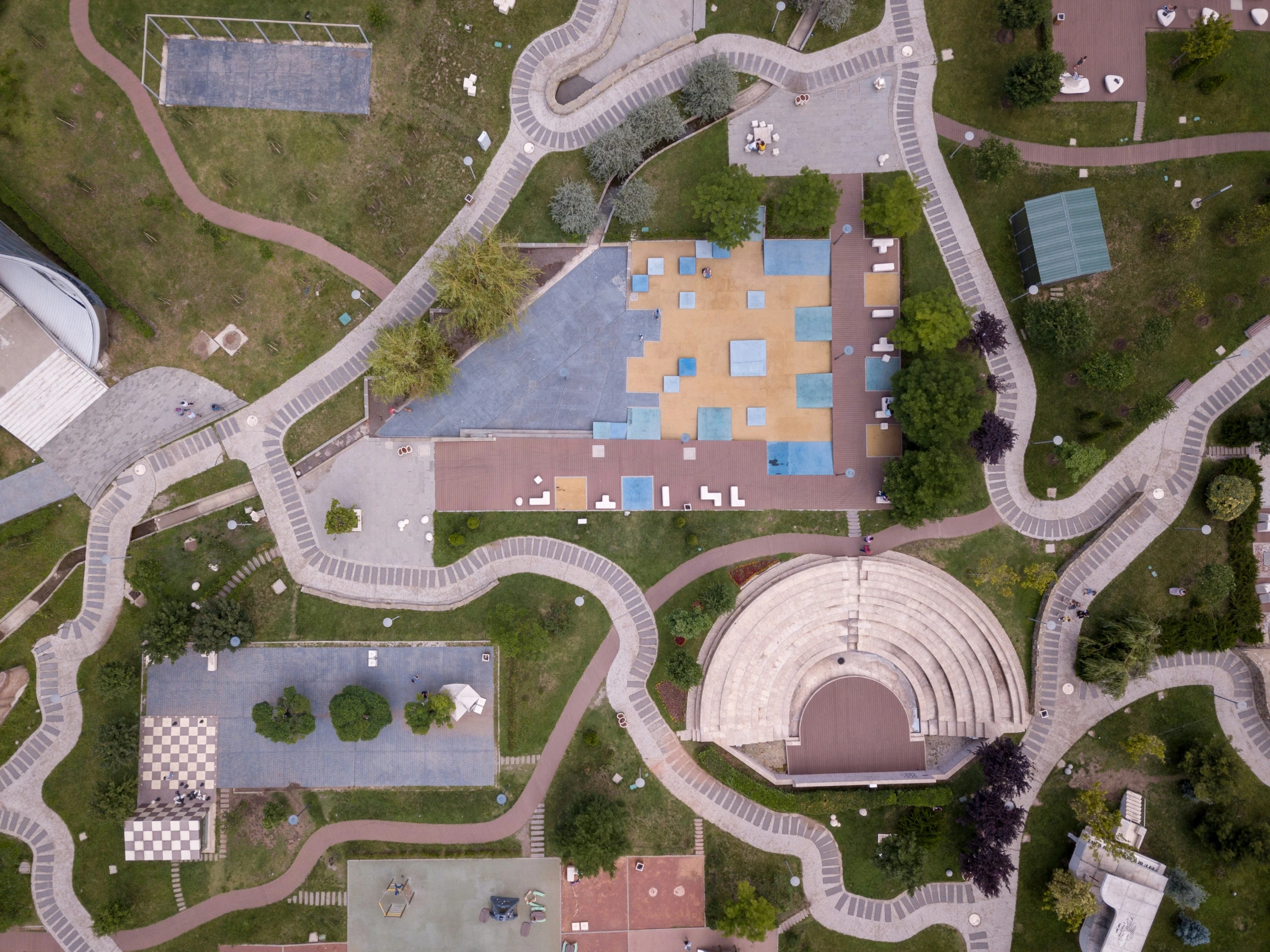 a large park with many buildings and a playground on it