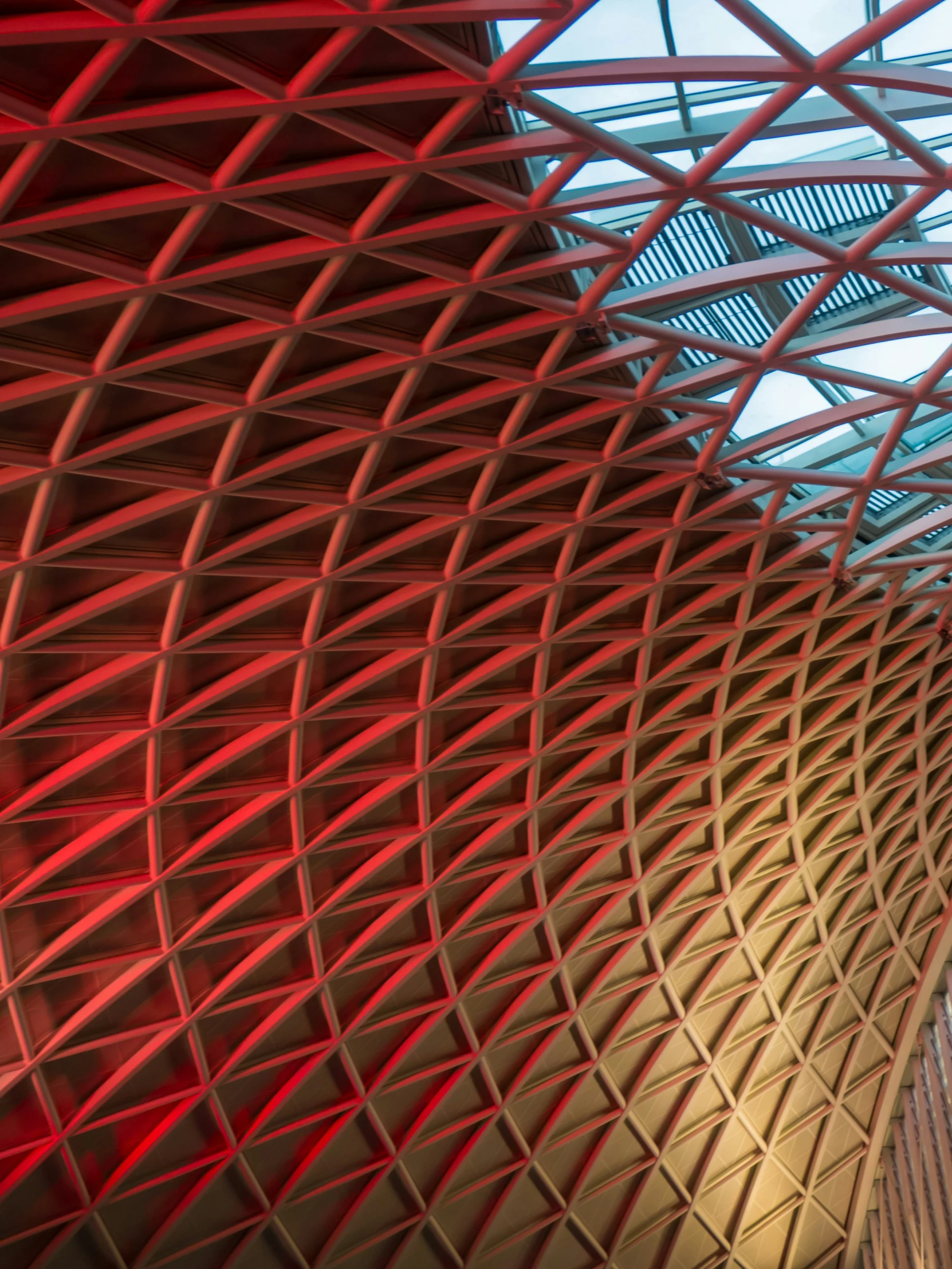 large, intricate, red, triangular building with a light