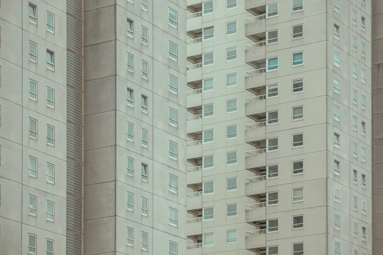 two building with grey and white architecture as well as a person taking a picture