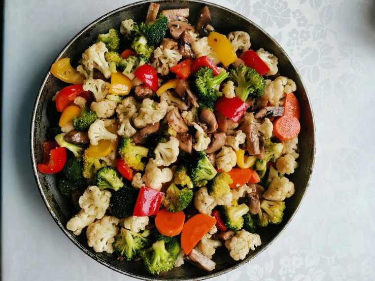 this is a bowl of vegetable salad on the table