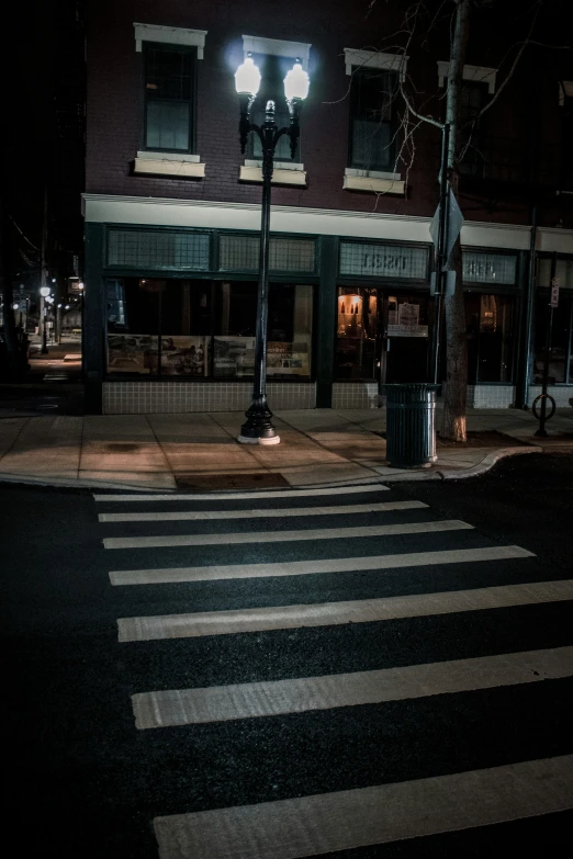 an empty street at night with a street light