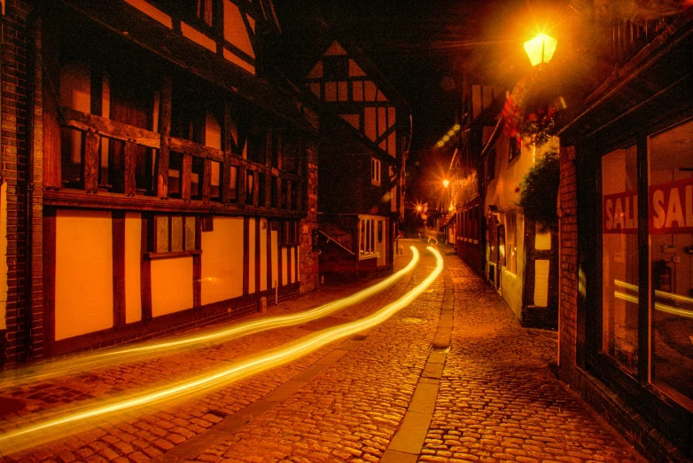a dark city street with the light streaks streaking through it