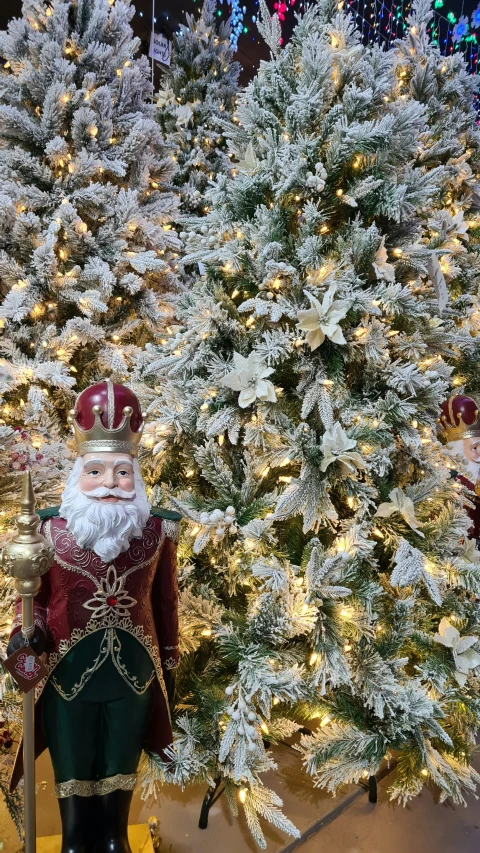 a christmas tree with snow on it and other decorations