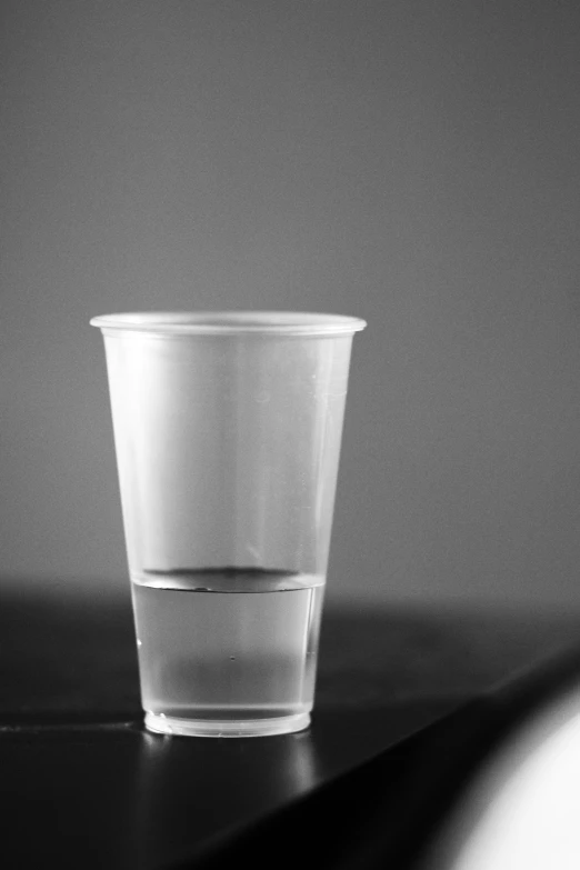 a single cup on a table is half empty
