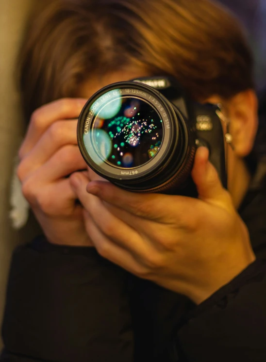 a person holding up a camera to their face