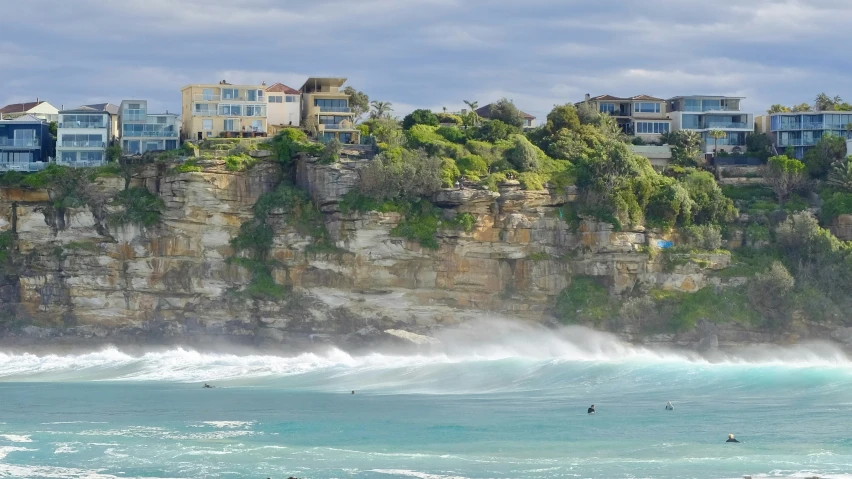 two people are riding surfboards in the ocean