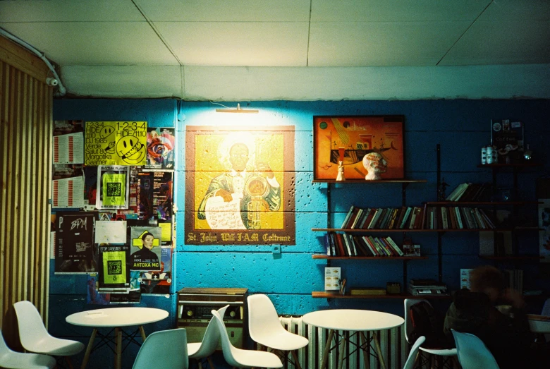 the interior of an art gallery with posters on the wall