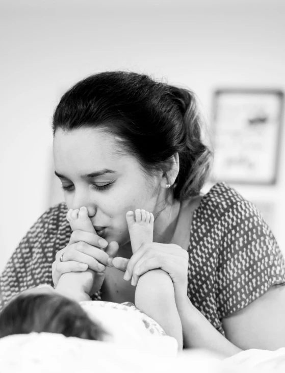 a woman and her baby on the bed