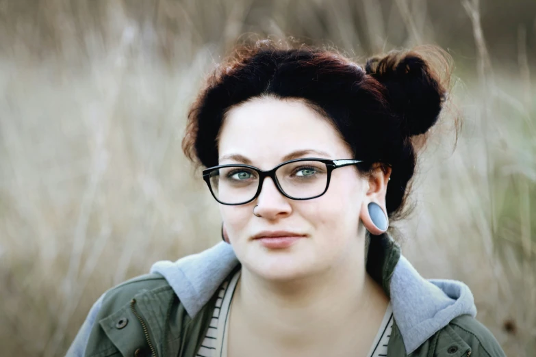 a young woman with glasses and an earplug