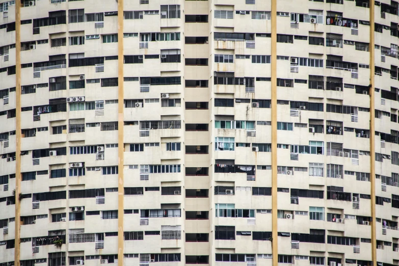 a high rise building with lots of windows and a street light on the side