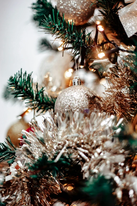 a christmas tree is covered in lights and bauble ornaments