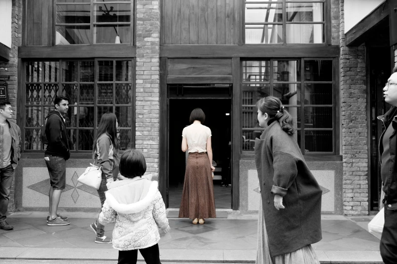 people on a city street in front of a building