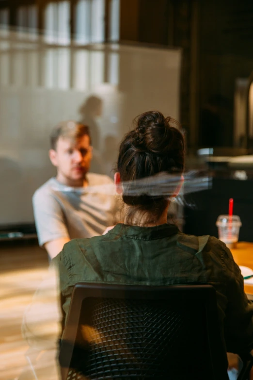 two people sitting next to each other in a room