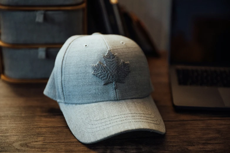 an old canadian maple leaf hat on a wooden table