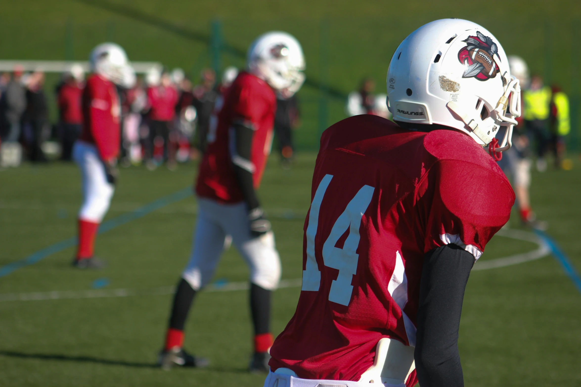 two young football players standing on a field