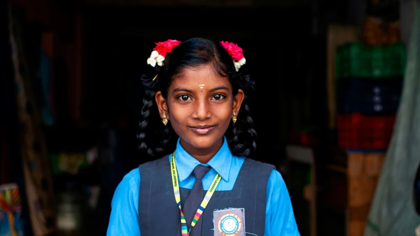 a little girl dressed up in her school uniform