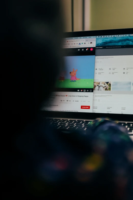 a person uses their laptop to video a soccer game