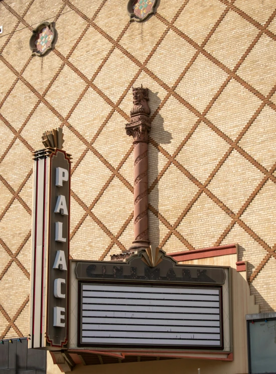 a sign for a theater is displayed against a decorative background