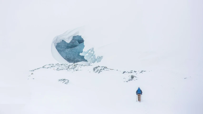 a skier and their equipment are covered in snow