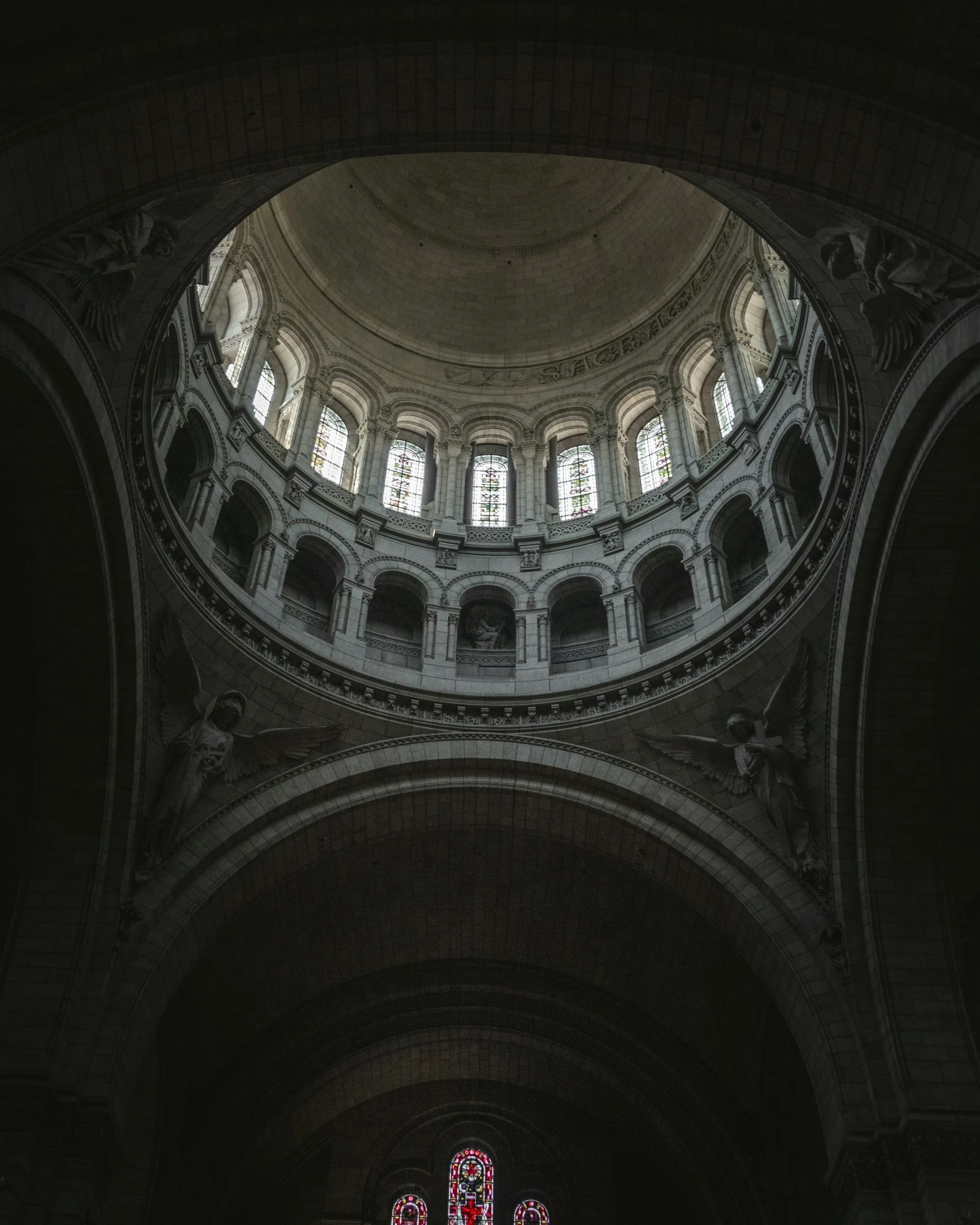 a couple of tall chairs underneath a large church window