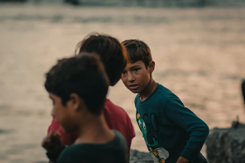 children looking at each other on the shoreline