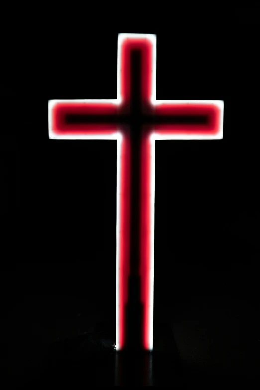 the cross is glowing on a black background